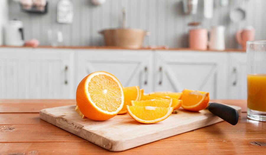 Orange slices on wooden chopping board