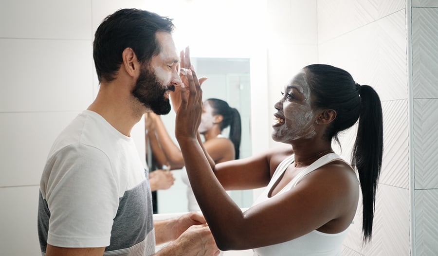 Couple doing a facial clay mask at home