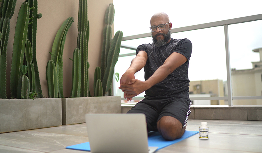 Mature healthy man stretching doing yoga outside