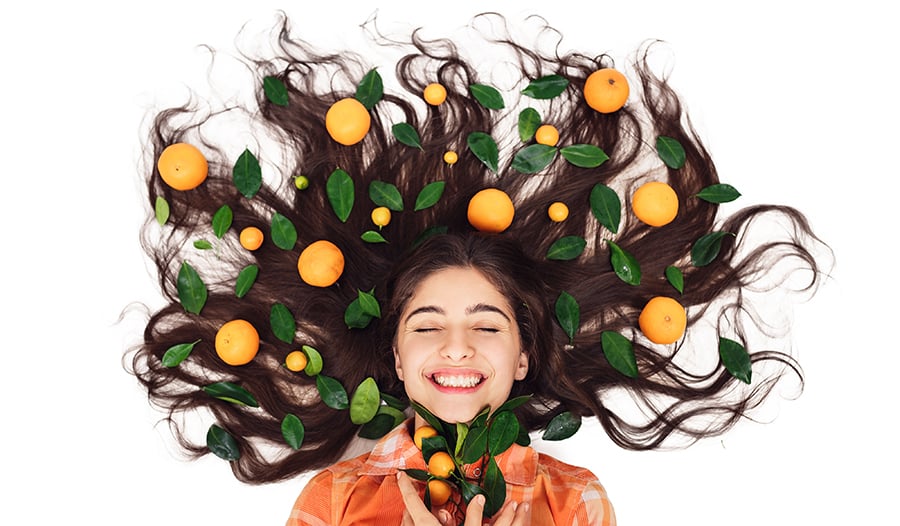 Healthy long hair with citrus fruits and leaves