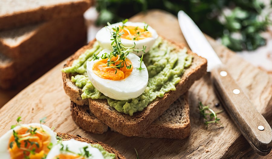 Healthy avocado toast with hard boiled eggs