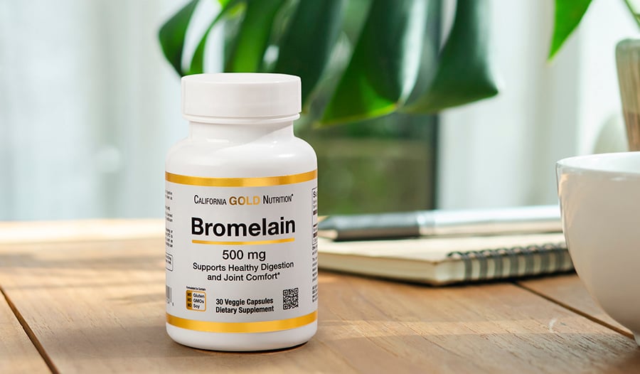 Bromelain supplement on desk table with plant in background