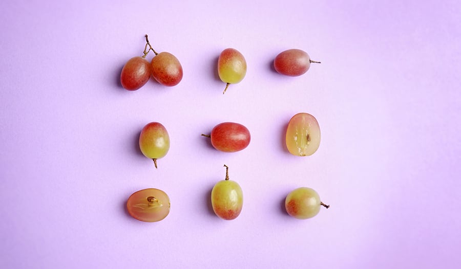 red grapes on purple background