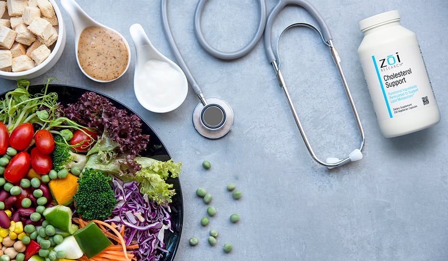 Healthy foods, stethoscope, and cholesterol supplement on table