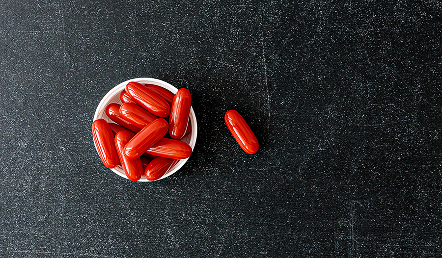 Coenzyme Q10 CoQ10 supplements in bowl on table