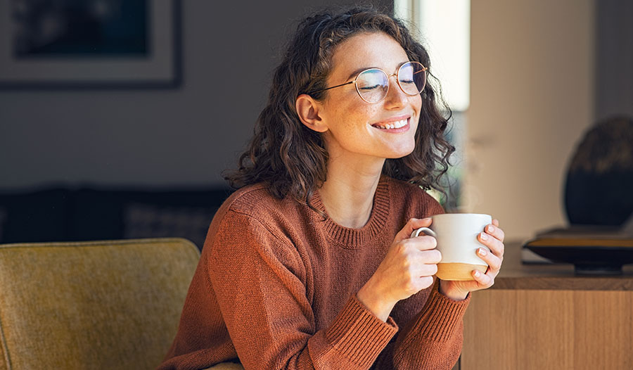 woman drinking collagen peptides in her morning coffee