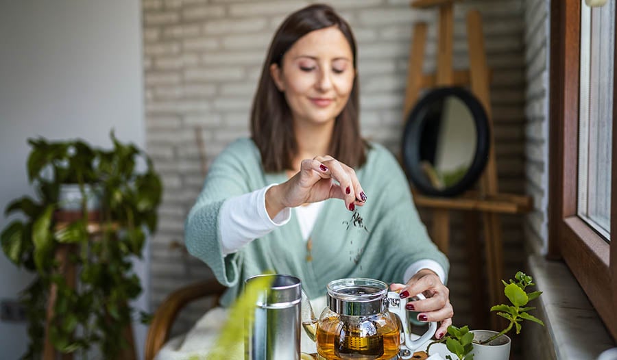 Woman making herbal tea at home