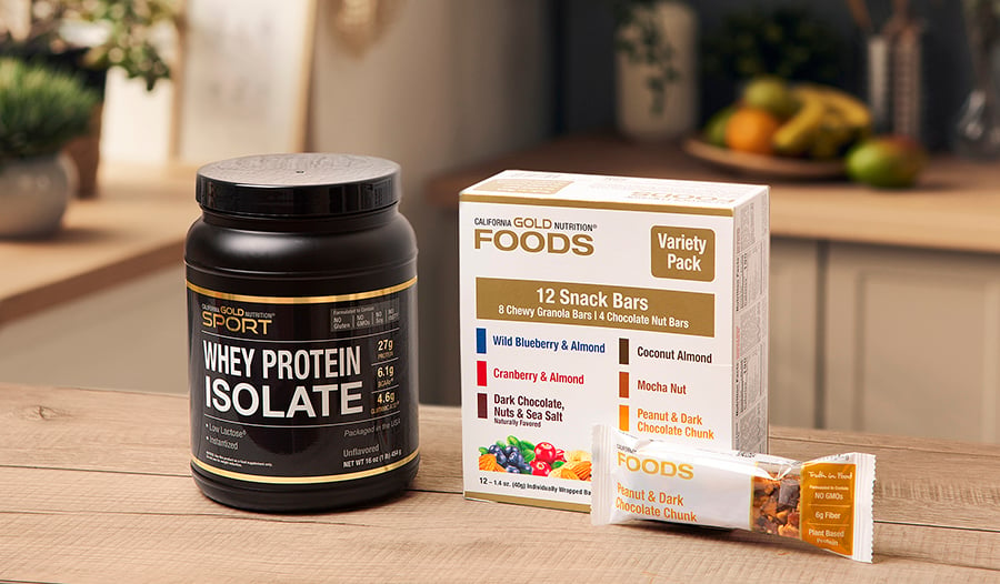Healthy snacks like whey protein and power bars on kitchen counter 