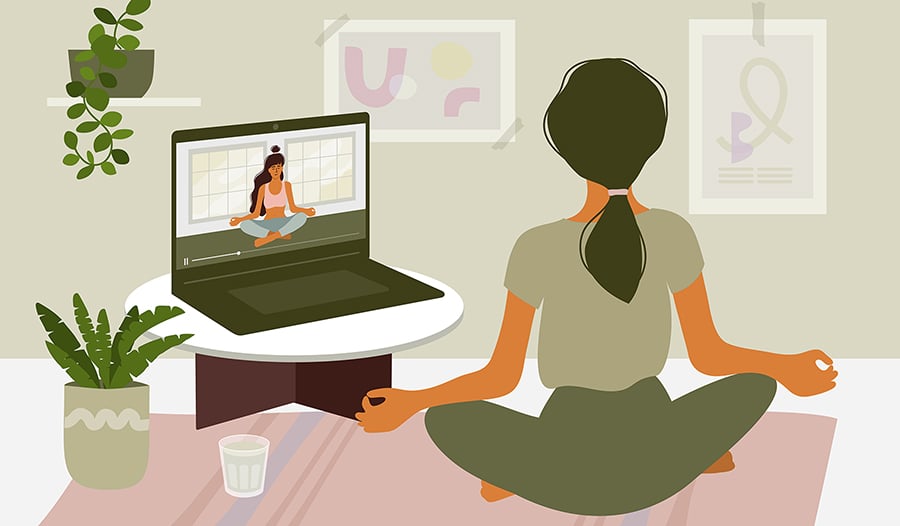 Female at home practicing yoga on laptop