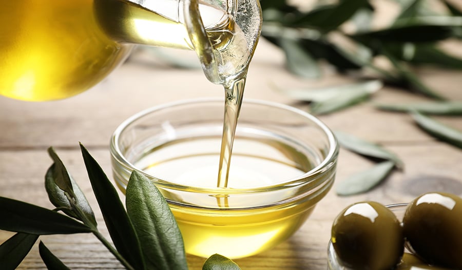 Extra virgin olive oil poured in a glass bowl