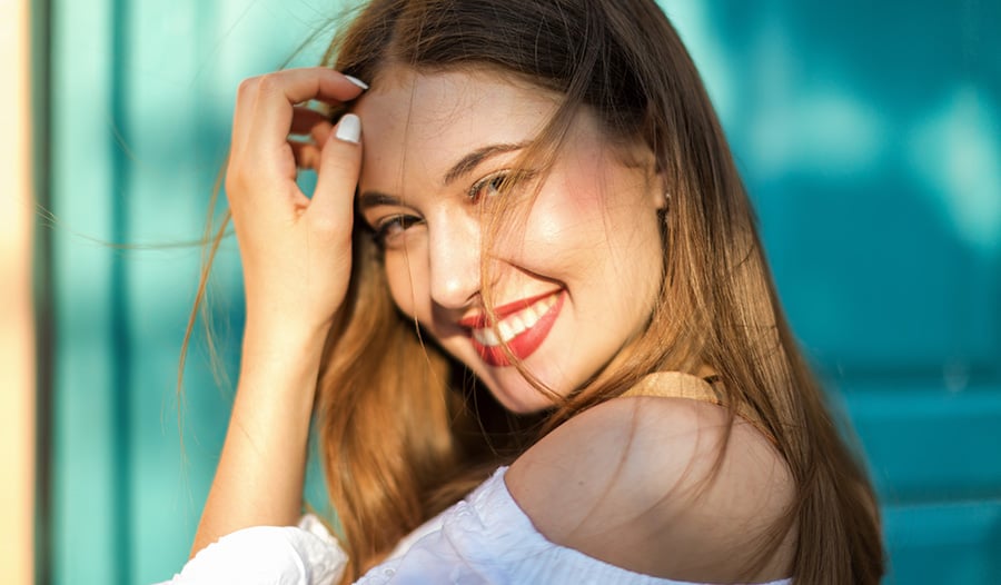 woman with glowy summer makeup smiling