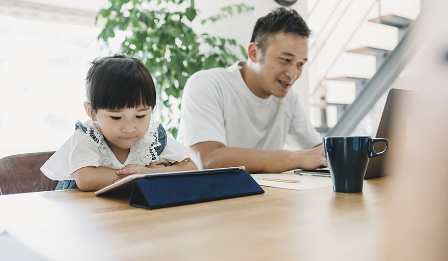 Father and daughter working together at home