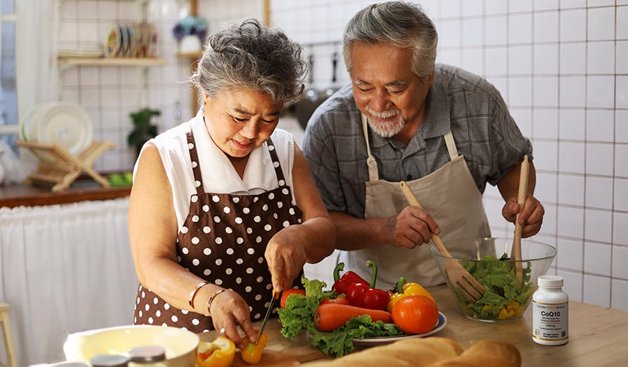 Mature couple making healthy meal in their kitchen