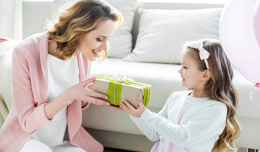 Daughter giving gift to mother on Mother's Day