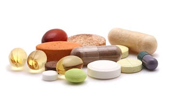 Supplements and vitamins on white background