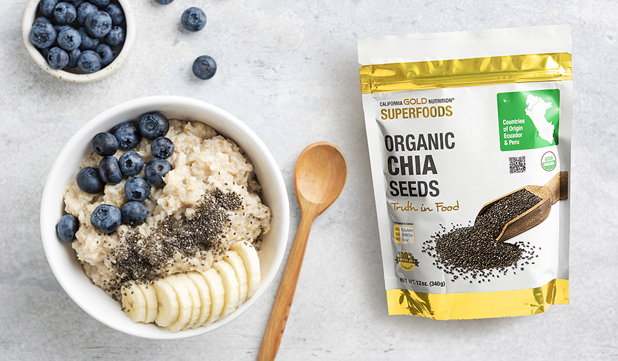 Oatmeal topped with blueberries, chia seeds, and banana on a granite counter