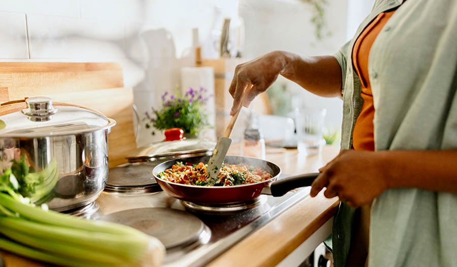 Woman cooking healthy meal at home