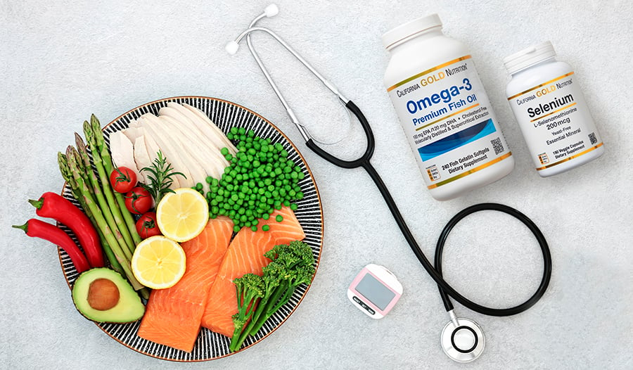 Plate of healthy foods, supplements, glucose monitor, and stethoscope