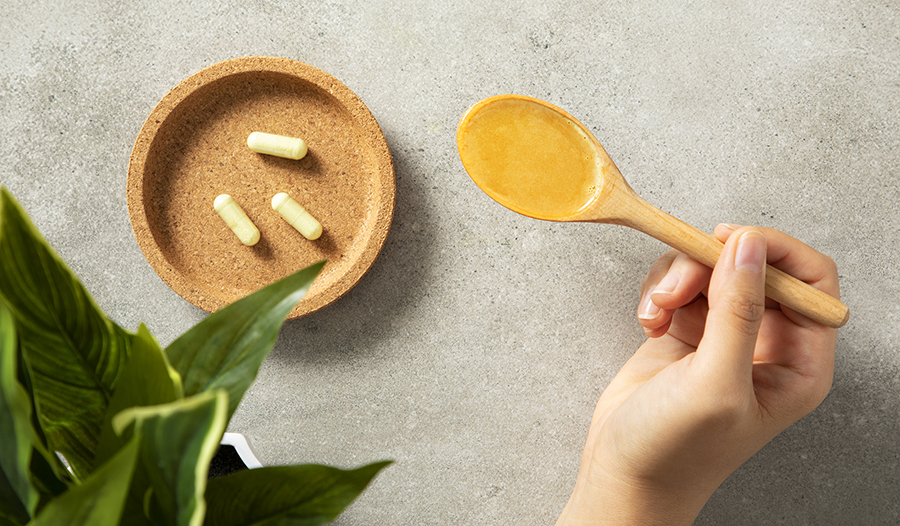 Liposomal supplements on table with plant