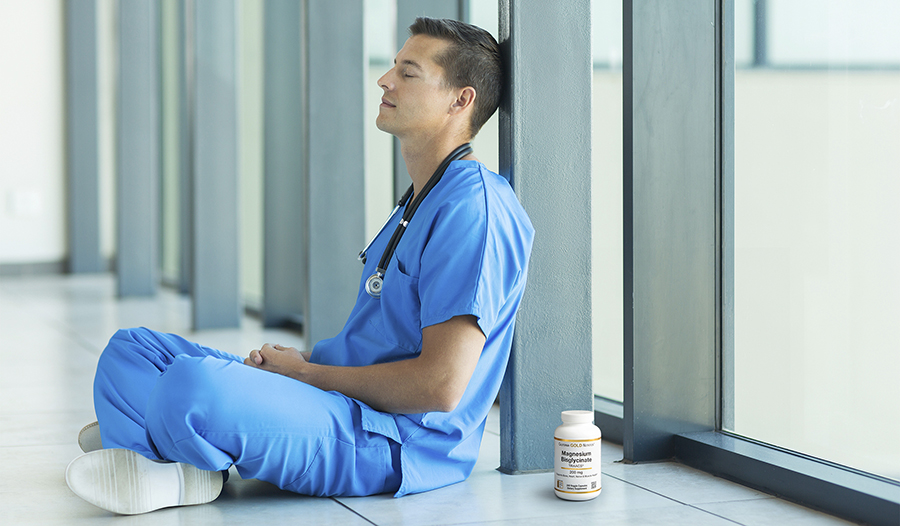 Doctor in scrubs taking a break sitting on the floor