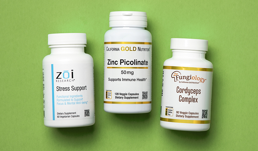 Stress support, zinc, and cordyceps supplements on green background