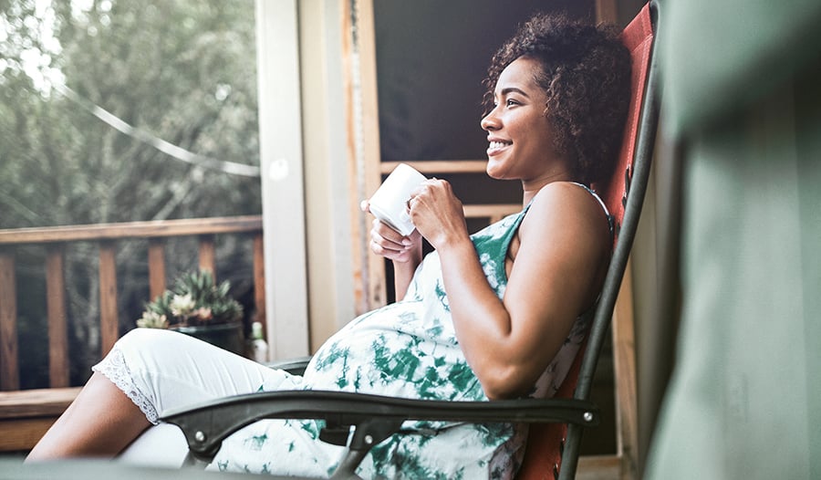 Pregnant Woman Relaxing Outside With Tea