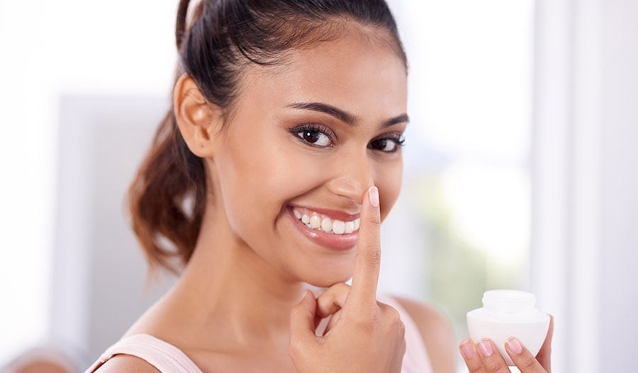 woman applying probiotic and fermented skincare to her face