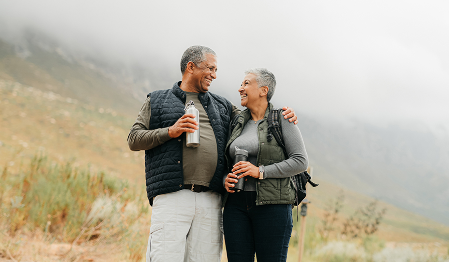 Healthy mature couple hiking in moutains