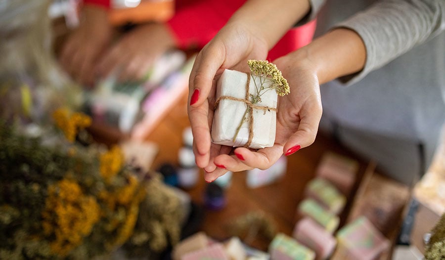 woman holding sustainable homemade bar soap with both hands