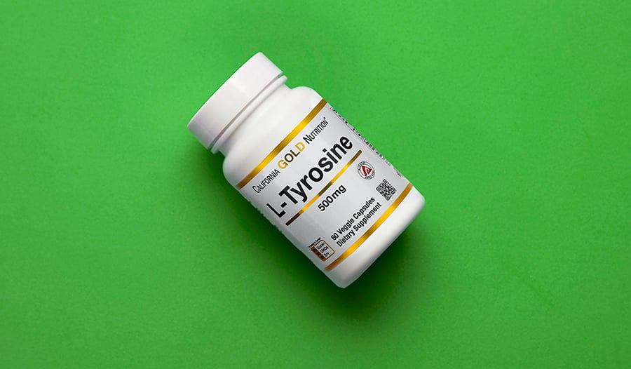Tyrosine supplement on green background
