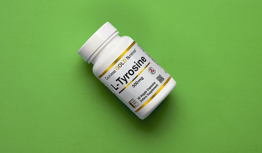 Tyrosine supplement on green background