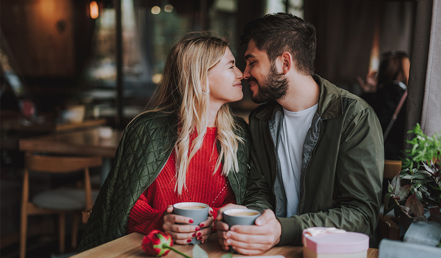 couple sitting in a coffee shop celebrating valentine's day