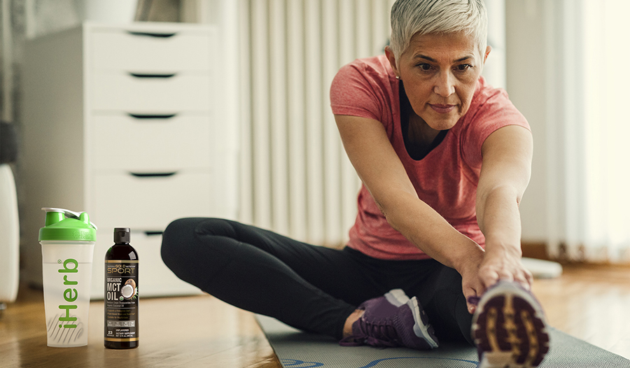 Mature woman stretching and working out from home