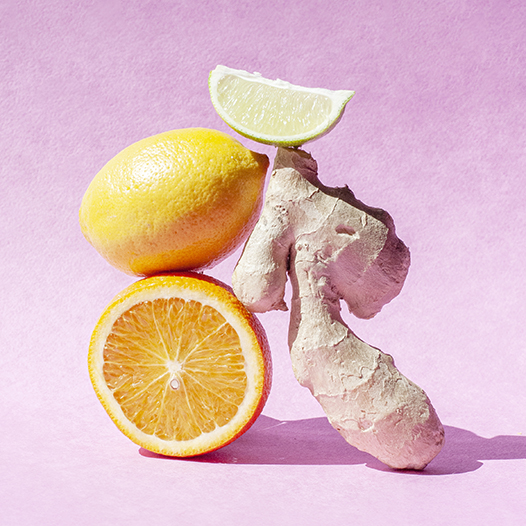 Ginger, lemon, and lime on pink background