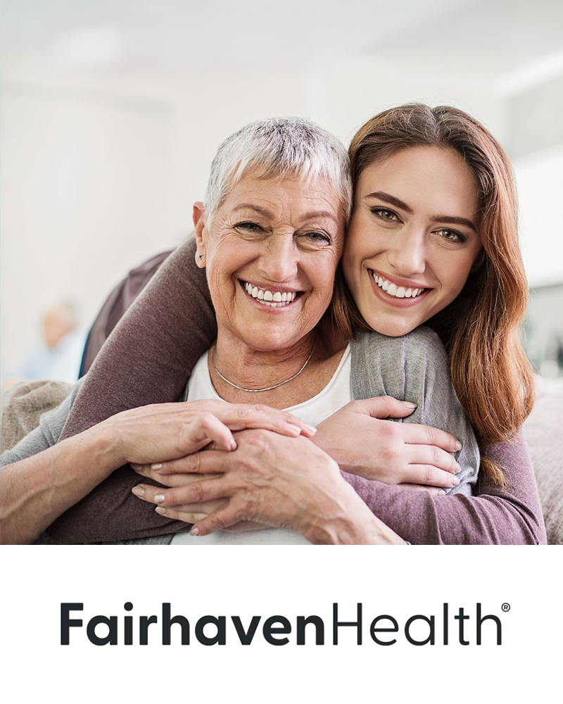 fairhaven health lifestyle brand image: An older woman and a younger woman smiling warmly, embracing each other