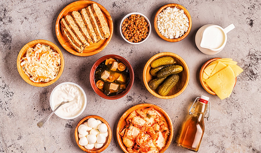 Table of fermented foods like kimchi, pickles, kombucha, yogurt
