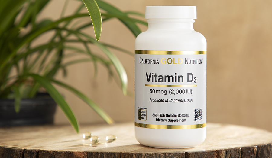 Vitamin D supplement on wooden table
